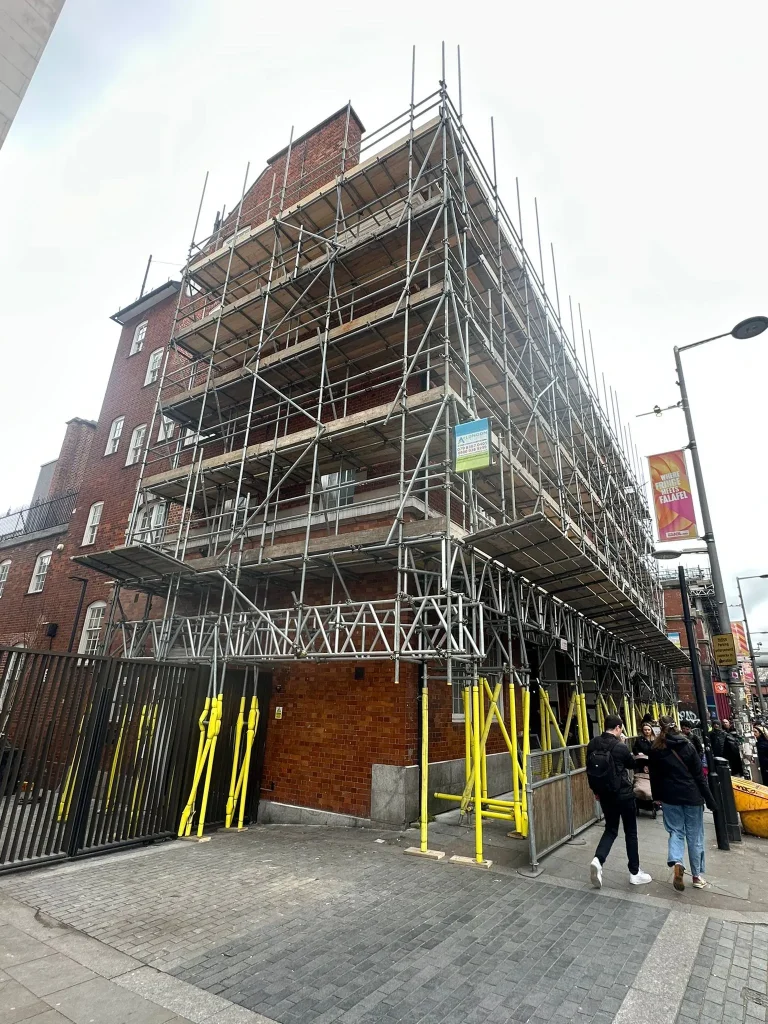 Large commercial tube and fitting scaffolding with pedestrian gantry installed by A Star London Scaffolding at Waterloo Road, London SE1.
